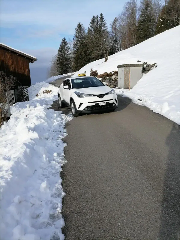 Nile Taxi on a snow-covered mountain road in the canton of Schwyz